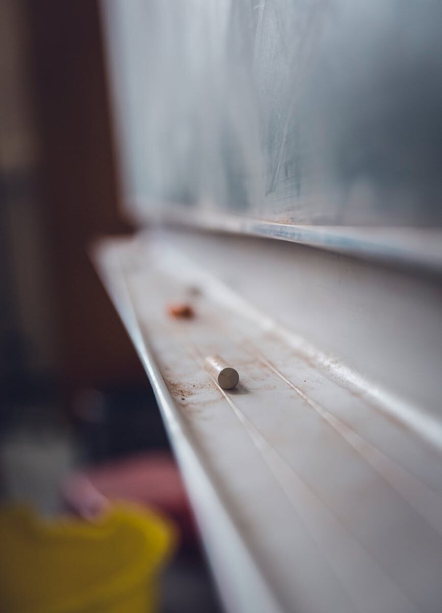 chalk laying in a chalkboard tray