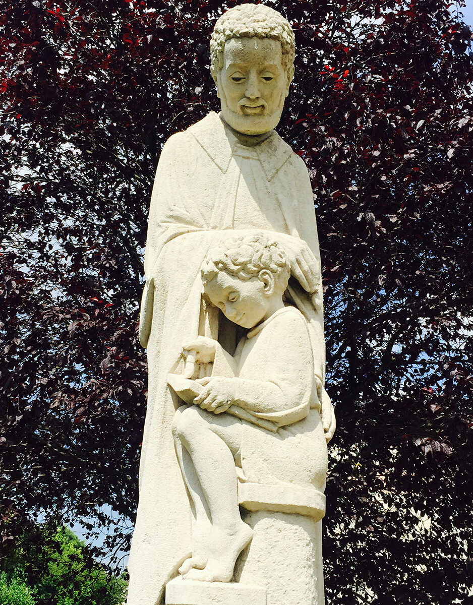 sculpture of St. Joseph teaching Jesus to write