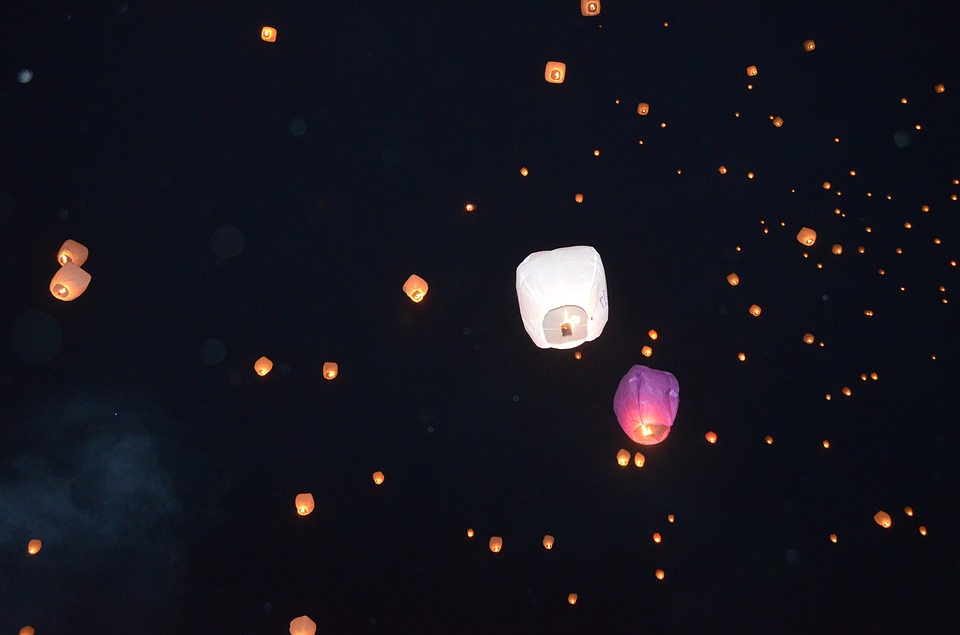 floating paper lanterns in night sky