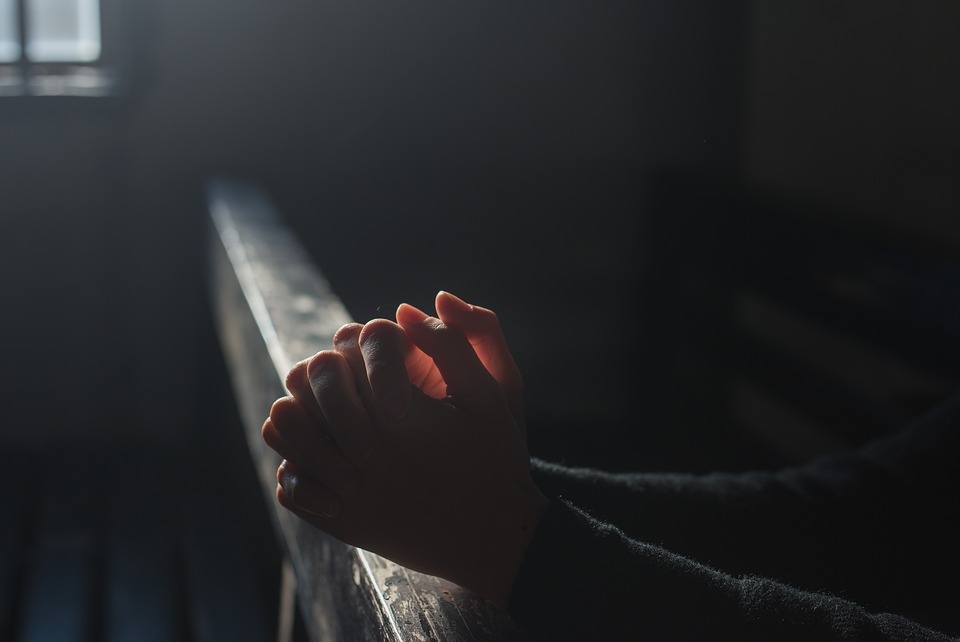 hands clasped for prayer